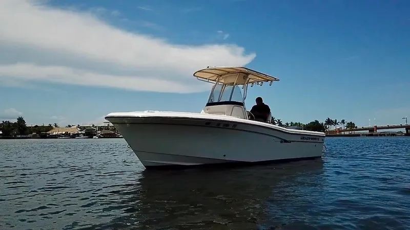 Slide: The Image of 2012 Grady-White Fisherman 230 boat on calm water under a clear blue sky. - 8