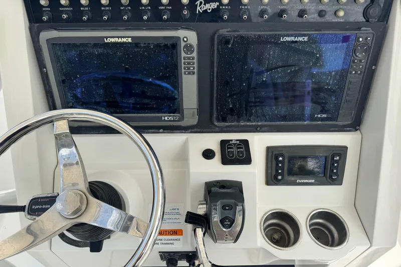 Slide: The Image of 2016 Ranger 2510 Bay Ranger dashboard with Lowrance displays and steering wheel. - 6