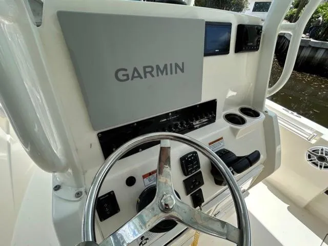 Slide: The Image of 2022 Cobia 240 Center Console boat with sleek design and spacious deck. - 11