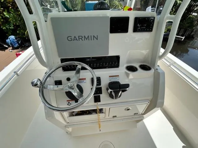 Slide: The Image of 2022 Cobia 240 Center Console boat helm with Garmin navigation system. - 12