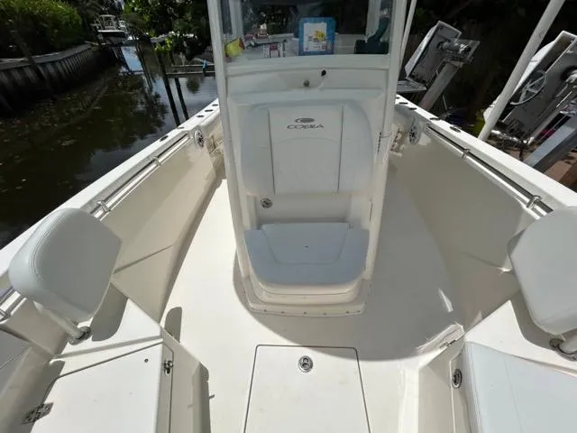 Slide: The Image of 2022 Cobia 240 Center Console boat deck with dual engines and fishing amenities. - 17