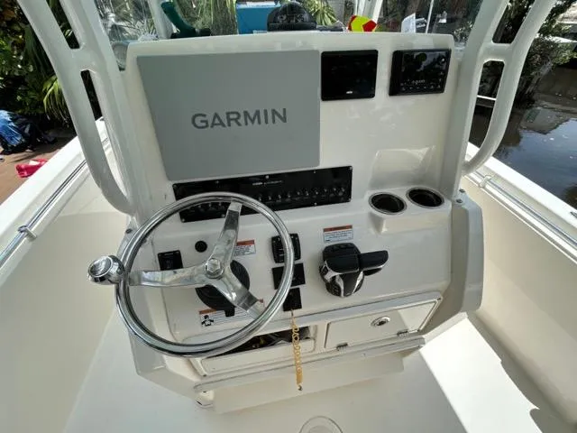 Slide: The Image of 2022 Cobia 240 Center Console boat interior with seating and console view. - 18