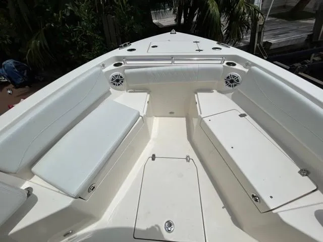 Slide: The Image of 2022 Cobia 240 Center Console boat dashboard with Garmin navigation system and steering wheel. - 19
