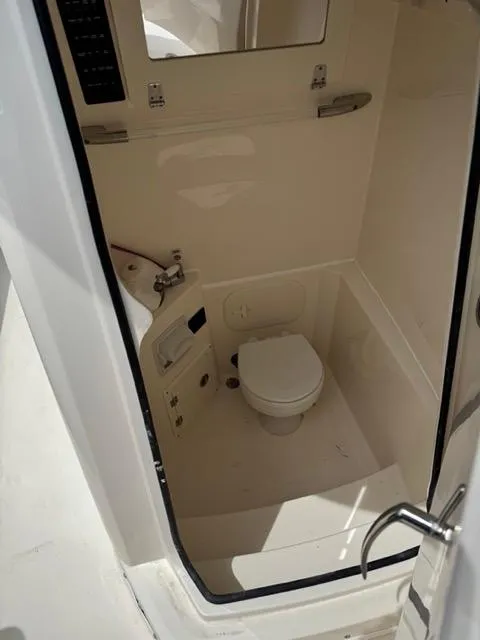 Slide: The Image of 2022 Cobia 240 Center Console dashboard with navigation display and controls. - 2