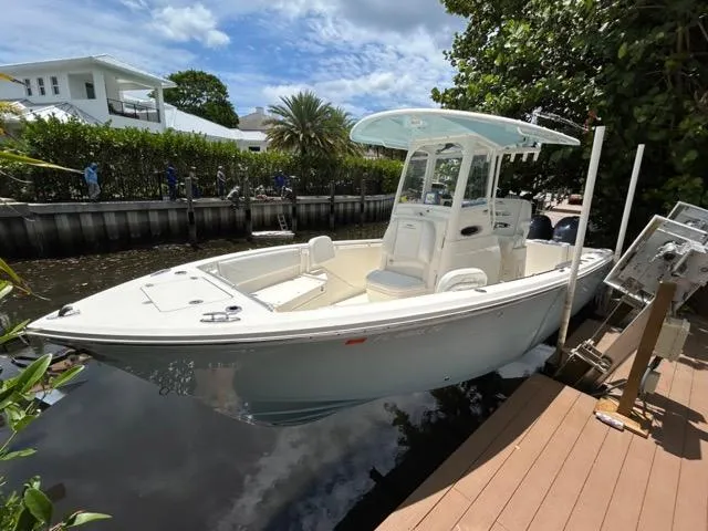 Slide: The Image of 2022 Cobia 240 Center Console boat interior with white seating and storage compartments. - 20
