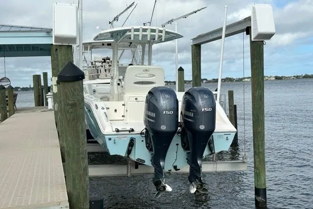 Slide: The Image of 2022 Cobia 240 Center Console boat interior with white seating and deck. - 26