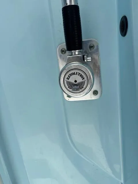 Slide: The Image of 2022 Cobia 240 Center Console boat interior with compact marine toilet and sink. - 3