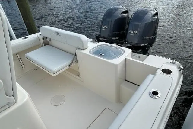 Slide: The Image of 2022 Cobia 240 Center Console boat with dual 150 engines and seating area. - 34