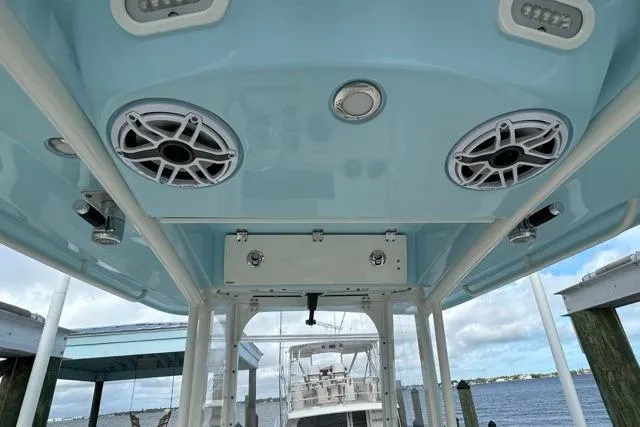 Slide: The Image of 2022 Cobia 240 Center Console boat with speakers and blue interior ceiling. - 41