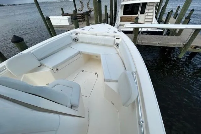 Slide: The Image of 2022 Cobia 240 Center Console boat docked, featuring spacious seating and sleek design. - 46