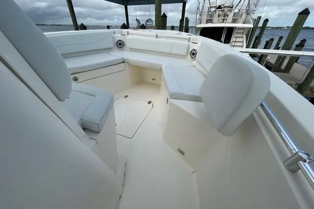Slide: The Image of 2022 Cobia 240 Center Console boat interior with white seating and storage compartments. - 47