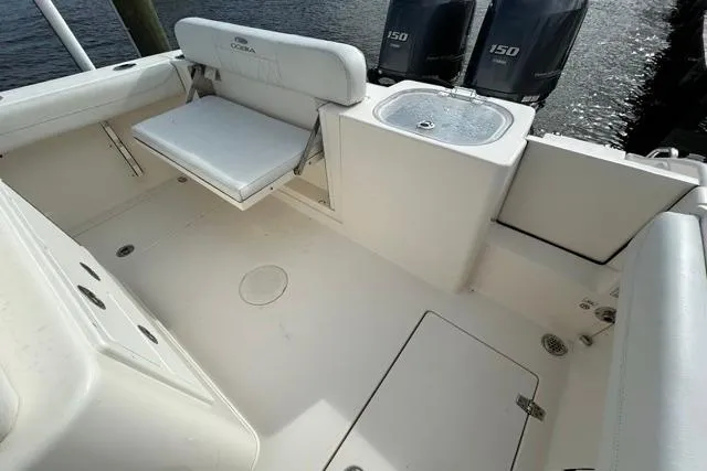 Slide: The Image of 2022 Cobia 240 Center Console boat interior with seating and dual 150 engines. - 49