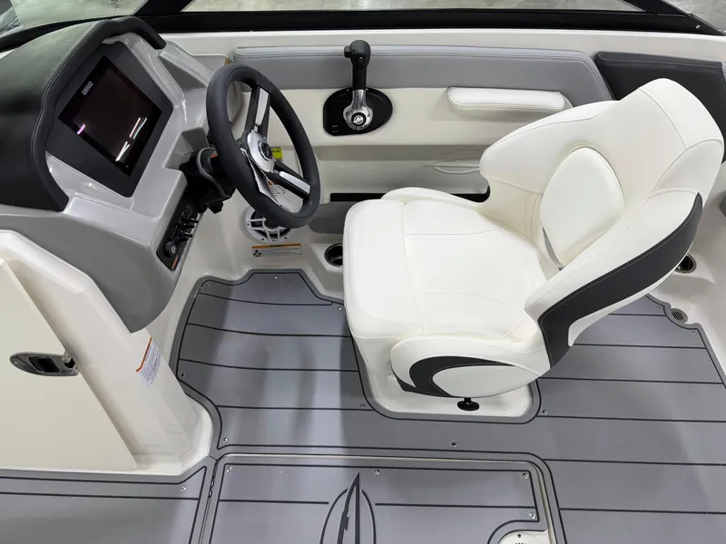 Slide: The Image of 2025 Chaparral 21 SSi boat interior with steering wheel and white captain's seat. - 12