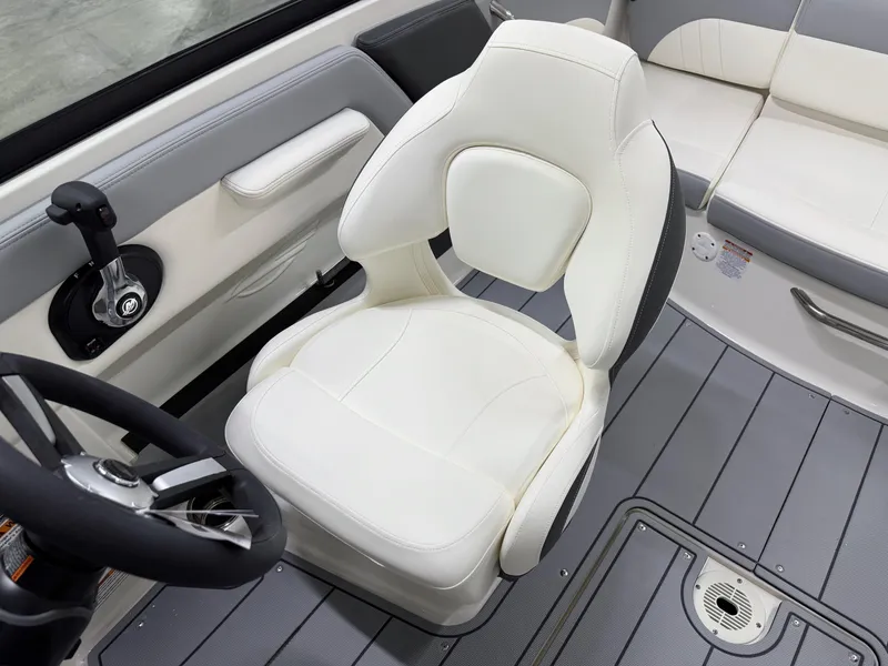 Slide: The Image of 2025 Chaparral 21 SSi boat interior with white captain's chair and steering wheel. - 13