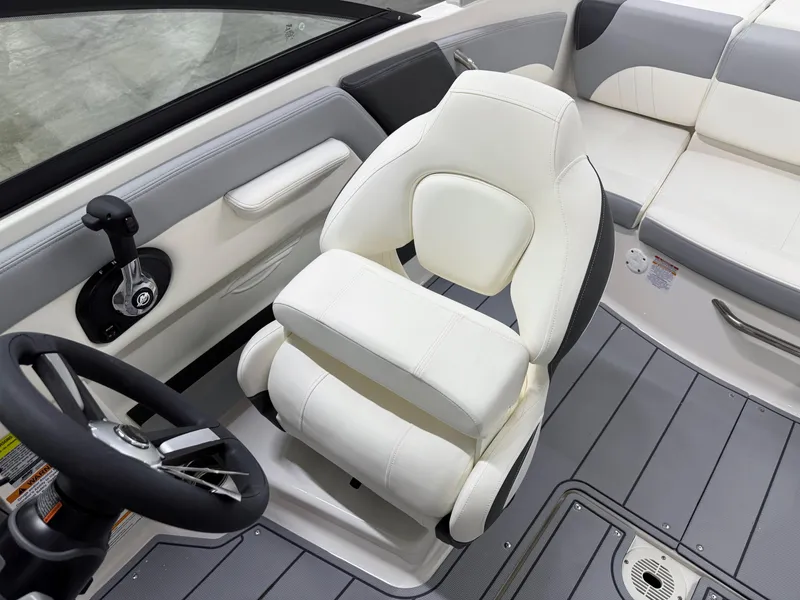 Slide: The Image of 2025 Chaparral 21 SSi boat interior with white captain's seat and steering wheel. - 14