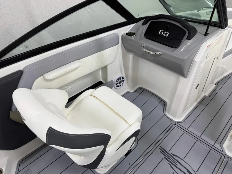 Slide: The Image of 2025 Chaparral 21 SSi boat interior with white seating and modern dashboard. - 15