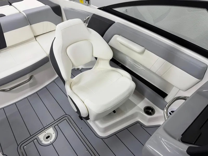 Slide: The Image of 2025 Chaparral 21 SSi boat interior with white and gray seating and flooring. - 16