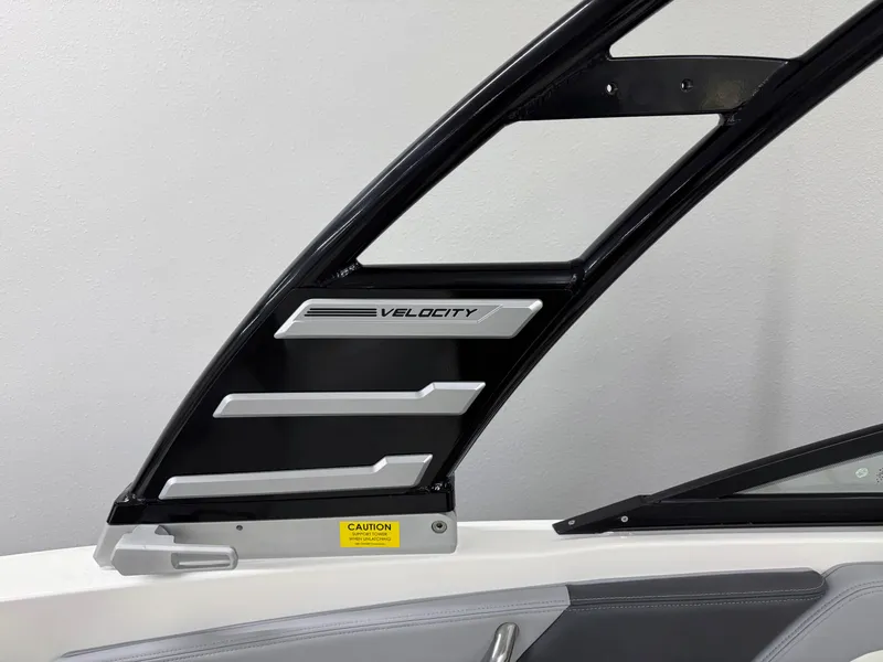 Slide: The Image of 2025 Chaparral 21 SSi boat interior detail with "Velocity" branding and caution label. - 26