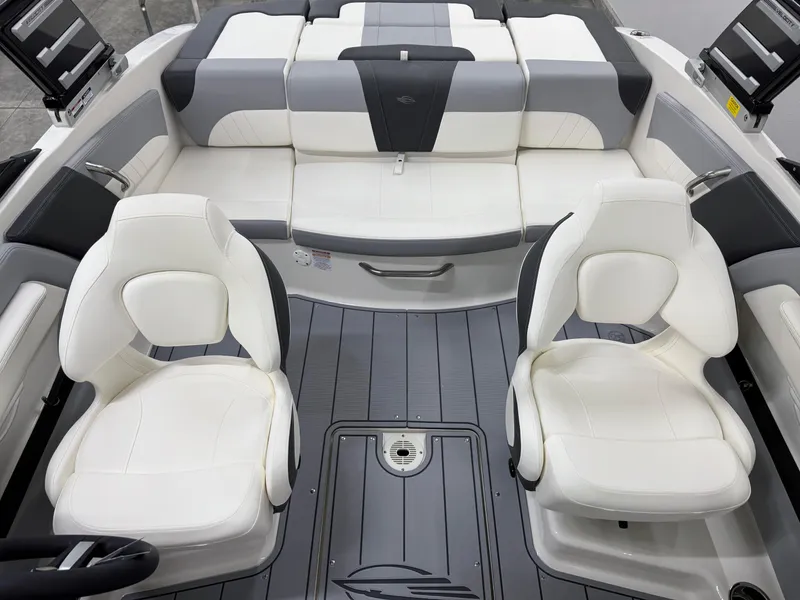 Slide: The Image of 2025 Chaparral 21 SSi boat interior with white and gray seating, modern design. - 7