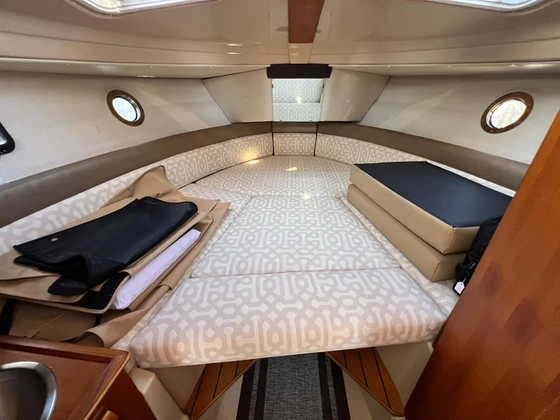 Slide: The Image of 2018 Ranger Tugs R23 cabin interior with patterned cushions and portholes. - 17