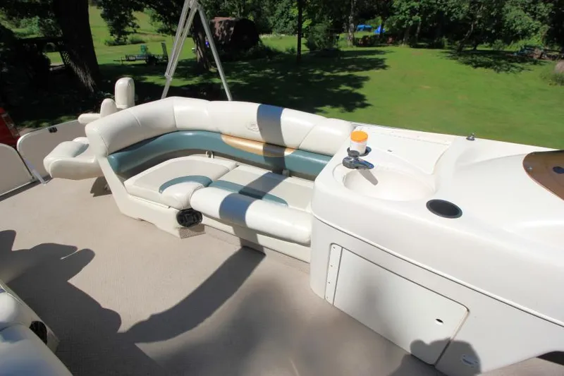Slide: The Image of 2002 Princecraft Versailles 22 SS boat interior with cushioned seating and built-in cup holder. - 11