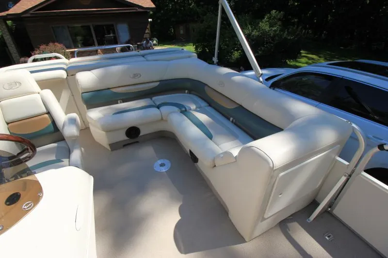 Slide: The Image of 2002 Princecraft Versailles 22 SS boat interior with plush seating and steering wheel. - 14