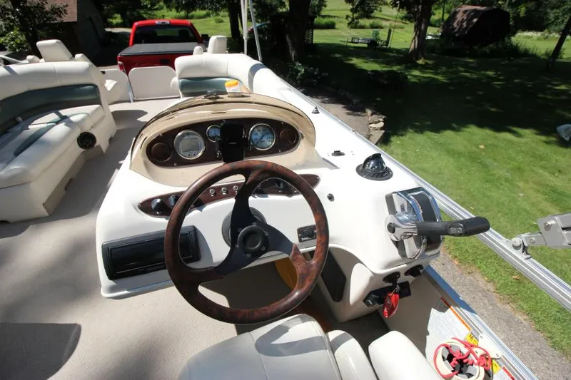 Slide: The Image of 2002 Princecraft Versailles 22 SS boat interior with steering wheel and dashboard controls. - 16