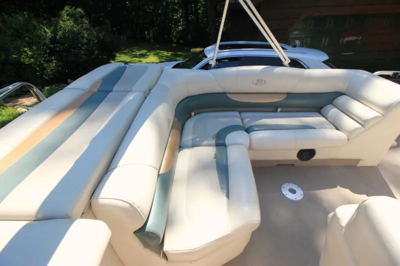 Slide: The Image of 2002 Princecraft Versailles 22 SS boat with spacious, cushioned seating in a serene outdoor setting. - 19