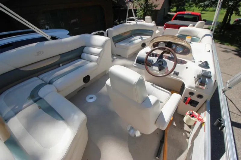 Slide: The Image of 2002 Princecraft Versailles 22 SS boat interior with white seating and steering console. - 20