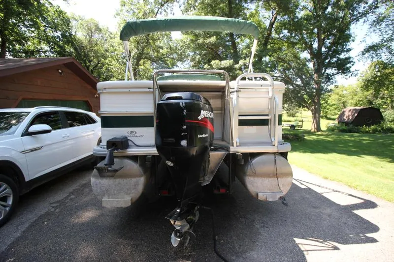 Slide: The Image of 2002 Princecraft Versailles 22 SS pontoon boat with Mercury outboard motor, parked outdoors. - 22