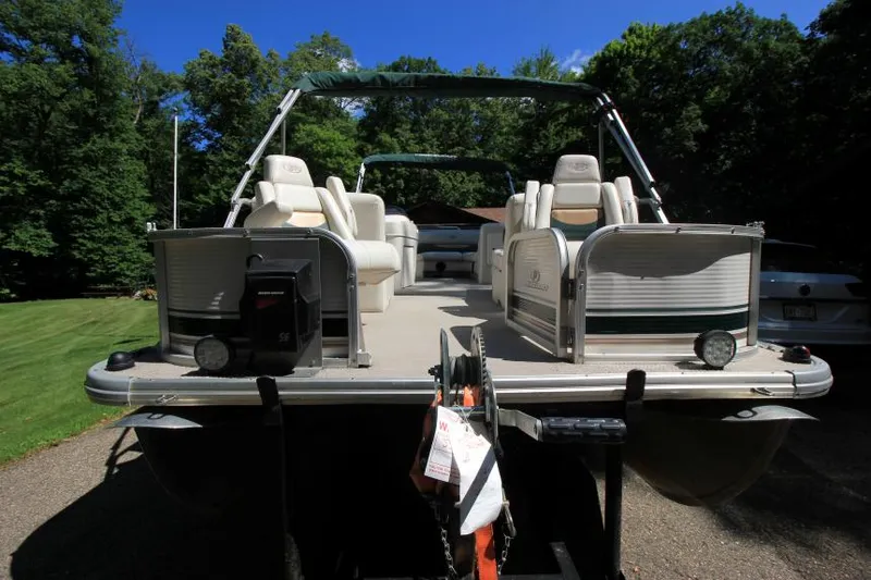 Slide: The Image of 2002 Princecraft Versailles 22 SS pontoon boat on trailer, surrounded by lush greenery. - 4