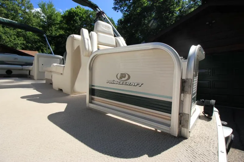 Slide: The Image of 2002 Princecraft Versailles 22 SS pontoon boat interior with seating and logo detail. - 6