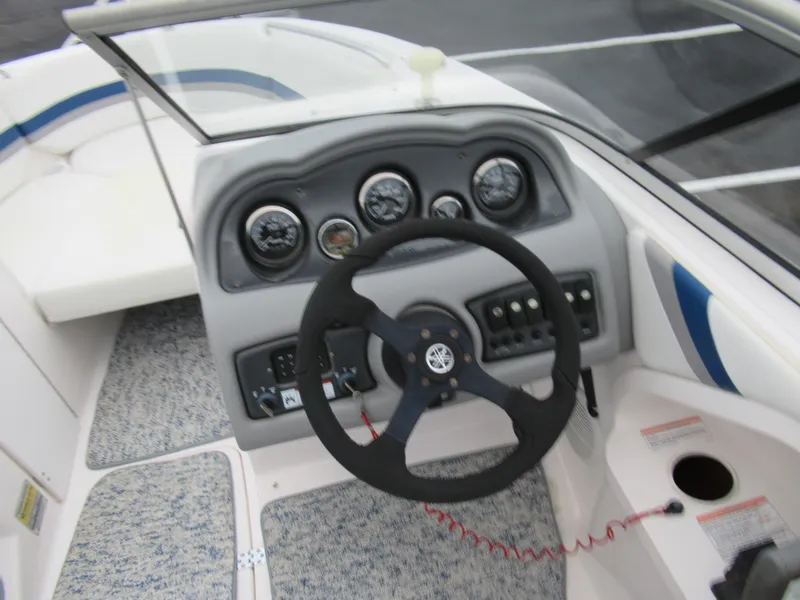 Slide: The Image of 2004 Yamaha Boats SX230 dashboard and steering wheel. - 11