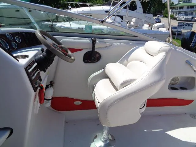 Slide: The Image of 2006 Crownline 220 CCR boat cockpit with white seating and steering wheel. - 11