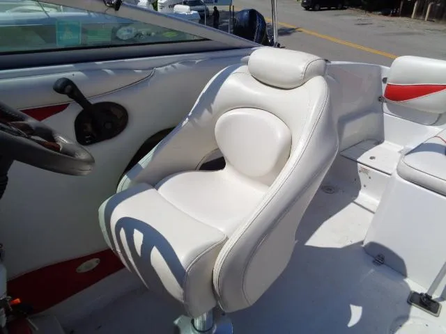 Slide: The Image of 2006 Crownline 220 CCR boat interior with white captain's chair and steering wheel. - 12