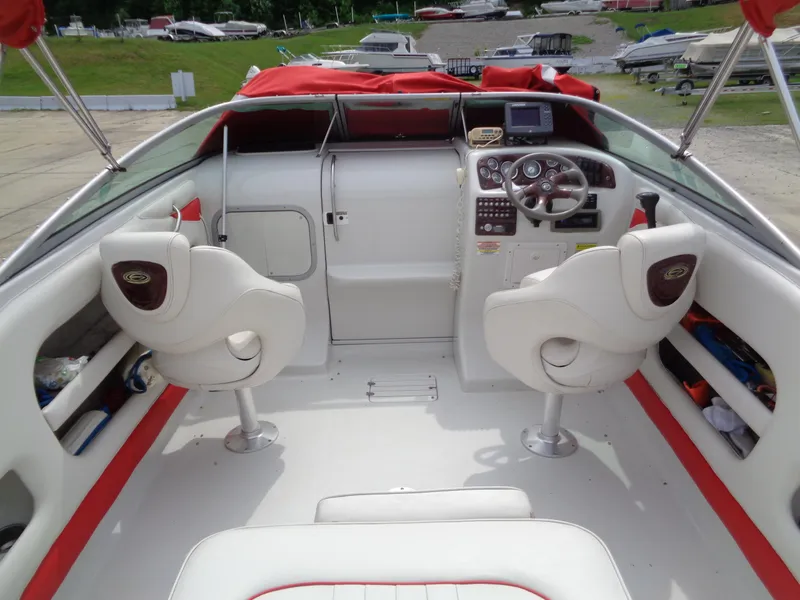 Slide: The Image of 2006 Crownline 220 CCR boat interior with white seats and red accents. - 13