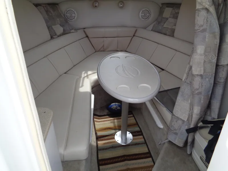 Slide: The Image of 2006 Crownline 220 CCR cabin interior with seating and table. - 18