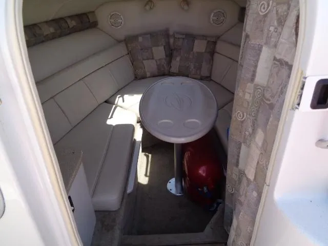 Slide: The Image of 2006 Crownline 220 CCR cabin interior with seating and table. - 19