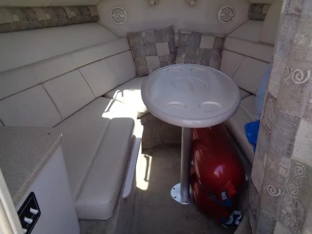 Slide: The Image of Interior of 2006 Crownline 220 CCR boat with cushioned seating and table. - 20