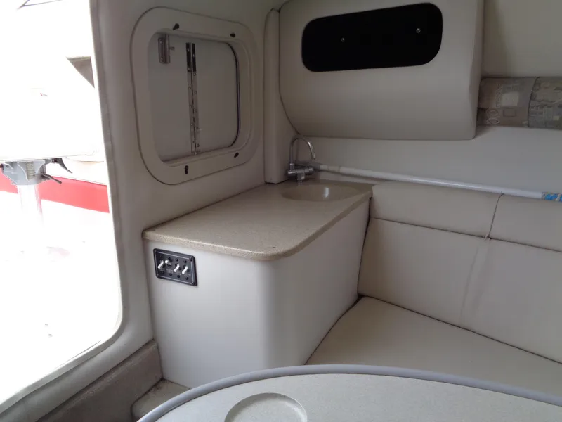 Slide: The Image of 2006 Crownline 220 CCR cabin interior with sink and seating area. - 22