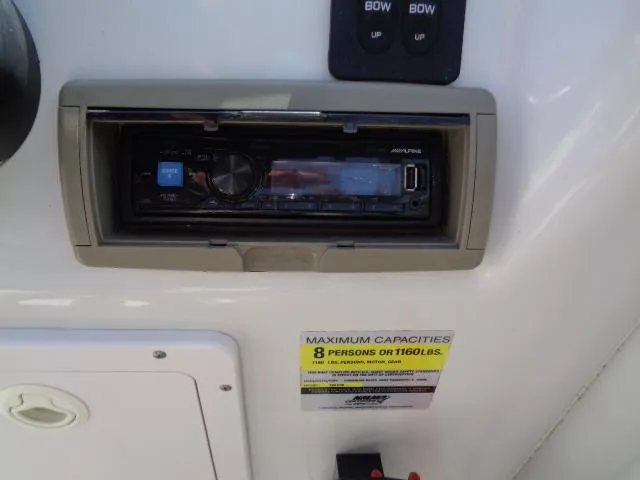 Slide: The Image of 2006 Crownline 220 CCR boat stereo system and capacity label, accommodating 8 persons or 1160 lbs. - 9