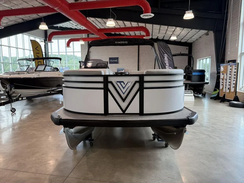 Slide: The Image of 2026 Viaggio V16U pontoon boat displayed in a showroom with modern design elements. - 2