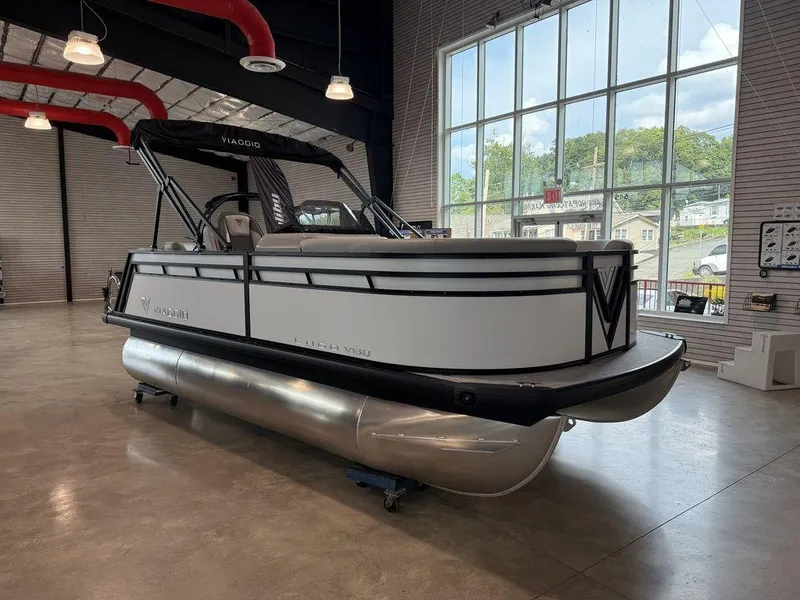 Slide: The Image of 2026 Viaggio V16U pontoon boat displayed indoors with large windows. - 3