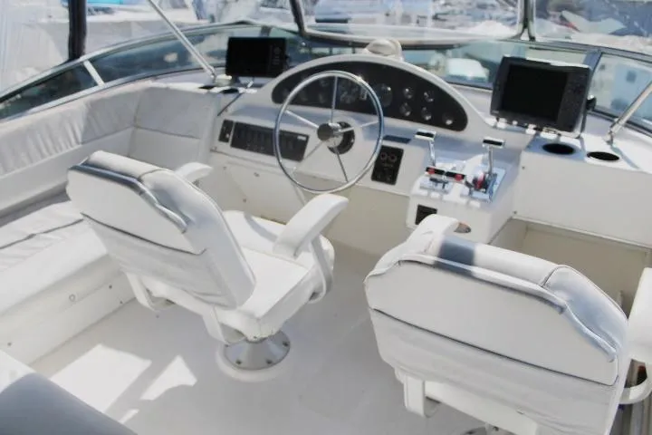 Slide: The Image of 1997 Bayliner 4087 Aft Cabin Motoryacht helm with dual seats and navigation equipment. - 10