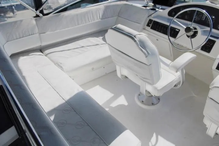 Slide: The Image of 1997 Bayliner 4087 Aft Cabin Motoryacht interior with white seating and steering wheel. - 12
