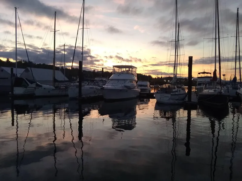 Slide: The Image of 1997 Bayliner 4087 Aft Cabin Motoryacht docked at sunset, surrounded by sailboats. - 2