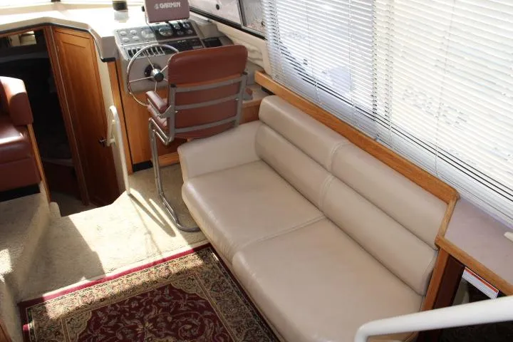 Slide: The Image of 1997 Bayliner 4087 Aft Cabin Motoryacht interior with beige seating and helm station. - 21