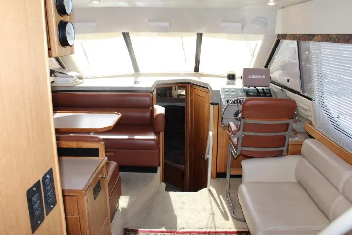Slide: The Image of 1997 Bayliner 4087 Aft Cabin Motoryacht interior with helm, seating, and dining area. - 22