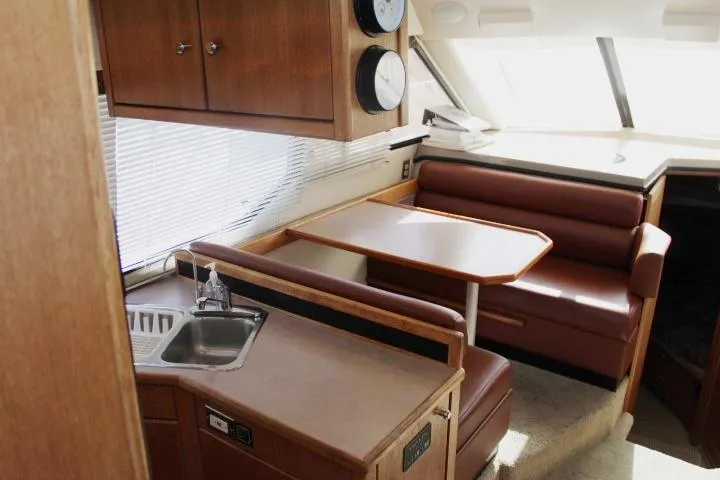 Slide: The Image of 1997 Bayliner 4087 Aft Cabin Motoryacht interior with dining area and kitchenette. - 23
