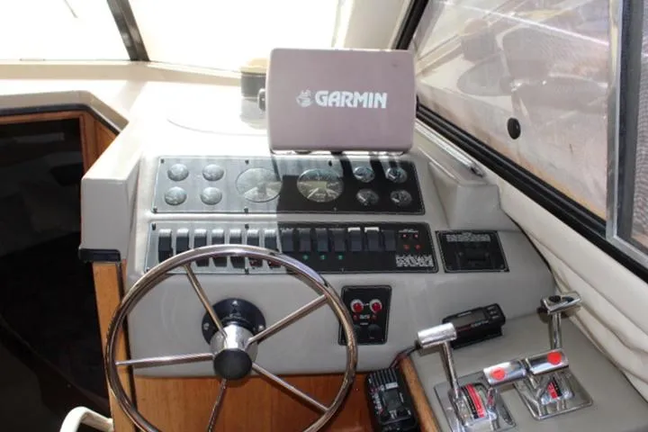Slide: The Image of 1997 Bayliner 4087 Aft Cabin Motoryacht helm with Garmin navigation system and control panel. - 27
